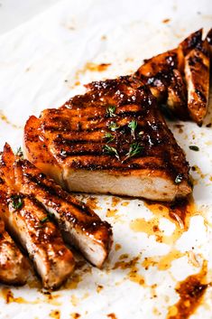 grilled meat sitting on top of a white plate