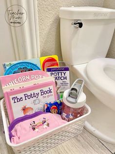 a basket filled with books next to a toilet