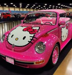 a pink car with hello kitty painted on it