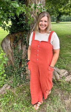 Super cute trend alert -> Get fall-ready with our Kyah Rust Overalls! Made from gauze fabric, this overall jumpsuit features a loose fit, front button detail, and wide leg pant bottoms. Perfect for any occasion, and yes, they have POCKETS! Relaxed Fit Wide Leg Jumpsuit For Day Out, Summer Wide Leg Jumpsuit With Button Closure, Cotton Jumpsuits And Rompers With Buttons For Day Out, Spring Loungewear Jumpsuits And Rompers With Buttons, Summer Jumpsuits And Rompers With Buttons And Relaxed Fit, Relaxed Fit Jumpsuits And Rompers With Buttons For Summer, Summer Relaxed Fit Jumpsuits And Rompers With Buttons, Casual Wide-leg Jumpsuits And Rompers With Button Closure, Casual Wide Leg Jumpsuits And Rompers With Button Closure