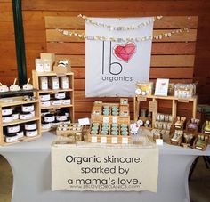 organic skin care products displayed on a table at a market stall with an i love sign