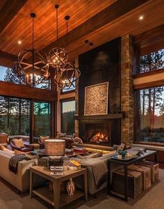 a living room filled with lots of furniture next to a fire place in a fireplace