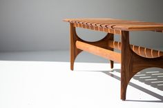 a wooden table sitting on top of a white floor