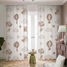 the curtains in this room are decorated with shells and starfishs, while the floor is made of wood