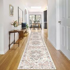 the hallway is clean and ready for guests to use it as an entrance way in this home