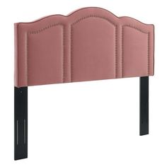 a pink headboard with black legs and stitching