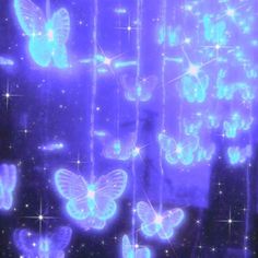 some blue butterflies hanging from strings in the dark night sky with stars and sparkles all over them