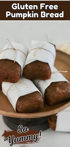 gluten free pumpkin bread is on a plate with white paper wrapped around it