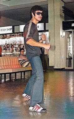 a young man riding a skateboard through a mall