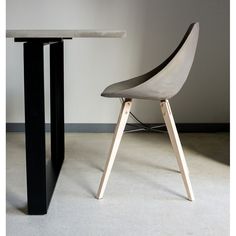 two black and white chairs sitting next to each other in front of a round table