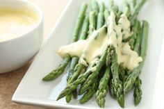 asparagus with cream sauce on a white plate