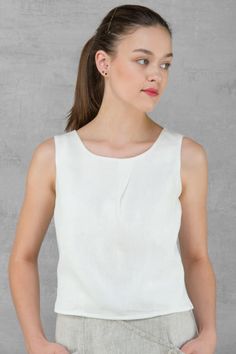 100% PURE LINEN BLOUSE Blouse made from optical white linen fabric. Simple, yet elegant, versatile garment, especially, looks great with our linen skirt and trousers. This subtle design blouse will be easy to match with any skirt, especially it will look great with our linen skirt. https://www.etsy.com/listing/510816562/linen-women-skirt-pure-linen-long-skirt?ref=shop_home_active_88 *Blouse without sleeves. *It has a rounded neckline. *Decorative detail - pleat in front. *Fitted at the back. *Fa Chic White Linen Tops, Elegant Sleeveless Linen Top, Classic Summer Linen Blouse, Modern Linen Blouse For Spring, Elegant Linen Spring Blouse, Chic Linen Top In Flax Color, Linen Workwear Top, Solid Linen Top For Work, Solid Linen Tops For Work