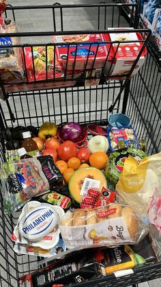 a shopping cart full of food and drinks