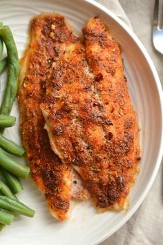 a white plate topped with meat and green beans