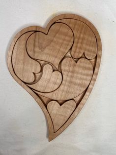 a wooden heart with hearts cut out of it