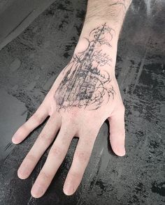 a person's hand with a tattoo on it