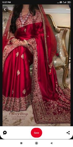 a woman in a red sari sitting on a couch