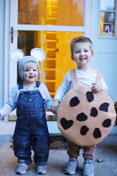 two children dressed up as mickey mouse and minnie mouse with their hands in each other's pockets