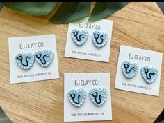 four earrings are sitting on top of a card with the words e olay co