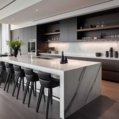 a kitchen with marble counter tops and bar stools