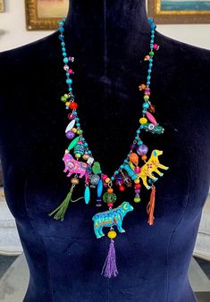 "This is a delightful and creative boho necklace hand-made by Lori Gutierrez! Lori took some figurines of animals, hand-painted them in a bright, colorful bohemian style, and assembled them onto a chain with many different colored beads, all resulting in a uniquely colorful, fun and charming one-of-a-kind work of jewelry art!   The beaded chain is 25\".   Thanks for looking!!" Handmade Multicolor Necklace Souvenir, Hand Painted Beaded Bohemian Necklace As Gift, Bohemian Hand Painted Beaded Necklaces As Gift, Hand Painted Bohemian Beaded Necklace For Gift, Bohemian Hand Painted Beaded Necklace For Gift, Multicolor Bohemian Jewelry For Souvenir, Bohemian Multicolor Jewelry For Souvenir, Handmade Charm Necklaces For Festivals, Unique Handmade Charm Necklaces For Festivals