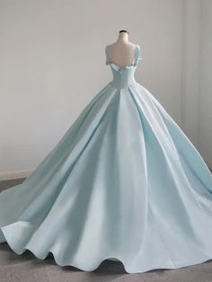 Elevate your quinceanera look with the timeless elegance of this Light Blue Satin Long Ball Gown Quinceanera Dress. The luminous satin fabric exudes sophistication, creating a smooth and luxurious finish that enhances the gown’s regal charm. The classic ball gown silhouette, paired with a flattering scoop neckline and sleeveless design, ensures a graceful and poised appearance. The soft pleats add subtle texture to the full skirt, lending depth and movement to the gown. Featuring a convenient zi Blue Sweet 16 Dress, Long Ball Dresses, Blue Sweet 16, Satin Long Prom Dress, Prom Dress Blue, Blue Ball Gown, Sweet 16 Dress, Blue Evening Gowns, Satin Formal Dress