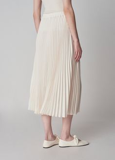 An easy pleated skirt rendered in Japanese stretch crepe. Clean minimalist elastic waistband. Calf length. Details Ivory 81% Triacetate, 19% Polyester 3028FATP-ESSN True to size Model is 5'11" and wears a size Small. Elastic Waist Skirt, Stretch Crepe, Waist Skirt, Pleated Skirt, Elastic Waistband, Elastic Waist, Elastic, Skirt, How To Wear