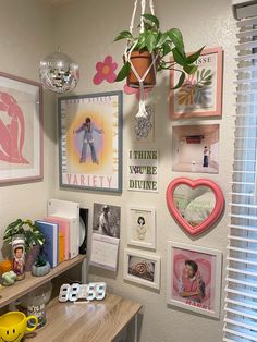 a room with pictures, plants and other decorations on the wall next to a window