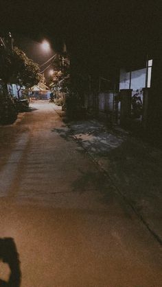 a person riding a skateboard down a street at night