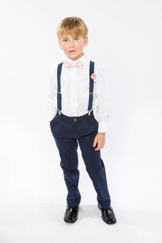 a young boy wearing a bow tie and suspenders