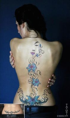 the back of a woman's body with tattoos on her lower back and side