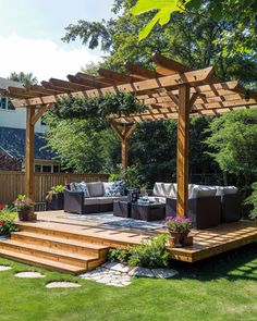 an outdoor living area with wooden decking and patio furniture, surrounded by lush green grass