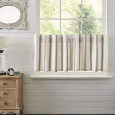 the curtains in this room are striped with white and grey stripes, along with an antique dresser