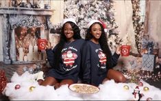 two women in matching christmas sweaters holding mugs