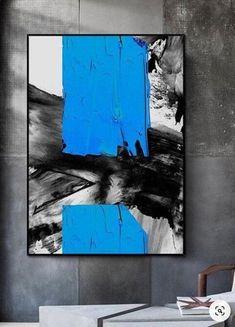 a blue and black abstract painting in a living room