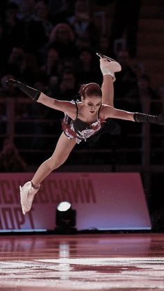 a female figure skating on an ice rink