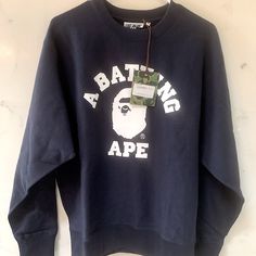 This Nwt A Bathing Ape Sweatshirt Features The Brand's Iconic College Logo. The Long-Sleeved Crewneck Is Made From Soft Cotton Material And Is A Size Medium. Perfect For Any Casual Outfit, This Authentic Bape Sweatshirt Is A Must-Have For Fans Of The Brand. Original Price: $265 (See Receipt) Aztec Statues, Long Sleeve Shirt Outfits, Shark Sweatshirt, Bape Shirt, Camo And Red, Bape Hoodie, Shark Hoodie, Camo Sweatshirt, College Logo