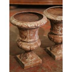 two old wooden candlesticks sitting next to each other on top of a table