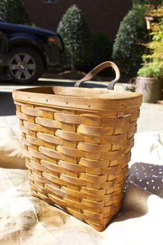 a brown basket sitting on top of a blanket