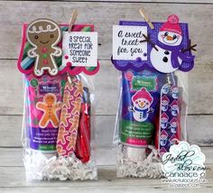 two packaged toothbrushes in plastic bags with snowman and reindeer decorations on them