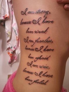 the back of a woman's stomach with words written in cursive writing