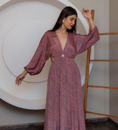 This exquisite maxi dress features a delicate pink fabric adorned with a subtle floral pattern, offering a touch of bohemian elegance. The design includes a flattering V-neckline that adds allure while remaining tasteful. Long sleeves provide coverage yet maintain the dress's airy feel, perfect for transitioning from day to evening wear. The dress flows gracefully to the floor, creating an elongated silhouette that flatters various body types. Its lightweight material ensures comfort and ease of Party Gown, Elegant Party, Anniversary Gift For Her, Party Gowns, Pink Fabric, Floral Maxi, Dress Clothes For Women, Floral Maxi Dress, Evening Gown