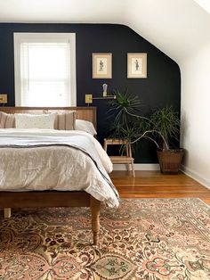 a bed sitting in a bedroom on top of a wooden floor next to a window