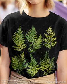 This fern leaves t-shirt is perfect for the fern lover to wear at a social gathering, on a hike, or even just as an everyday outfit. It is a great gift for anyone who spends their time enjoying nature's outdoor activities, plant nurseries, and botanical gardens. With a timeless inspired original design, this graphic tee will remain stylish for countless years to come. FABRIC CONTENT:  - Fabric content varies based on color. Solid colors are 100% cotton, heather colors are 52% cotton/48% polyeste Green Short Sleeve Tops With Plant Print, Green Tops With Plant Print Short Sleeves, Green Graphic Tee With Plant Print, Green Graphic Tee With Plants Print, Botanical Green Tops With Plant Print, Green Botanical Print Tops, Spring Green Tops With Plant Details, Green Botanical Graphic Print Tops, Botanical Style Green T-shirt With Graphic Print