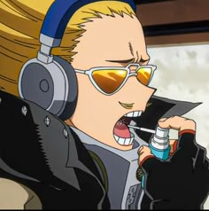 a man wearing headphones and holding a bottle in front of his face with an open mouth