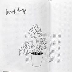 an open notebook with a drawing of a potted plant