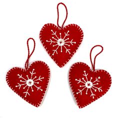 three red hearts with white snowflakes on them