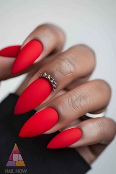 Go bold with these matte red almond-shaped nails, accented with a ring embellishment. Perfect for a striking and elegant fall style. Find more amazing nail ideas at NailHow.com and save this pin! Matte Red Nails Design, Red Matte Nails Design, Red Nail Designs Almond, Red Glam Nails, Matte Red Nails, Chiefs Jacket, Red Almond Nails, Elegant Almond Nails