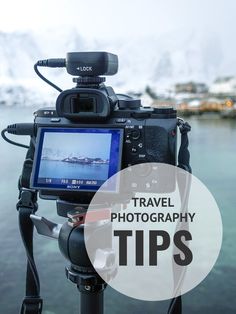 a tripod with the words travel photography tips on it in front of a body of water