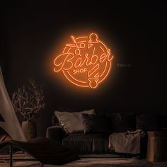 a neon sign that says baby shop in the middle of a dark room with furniture